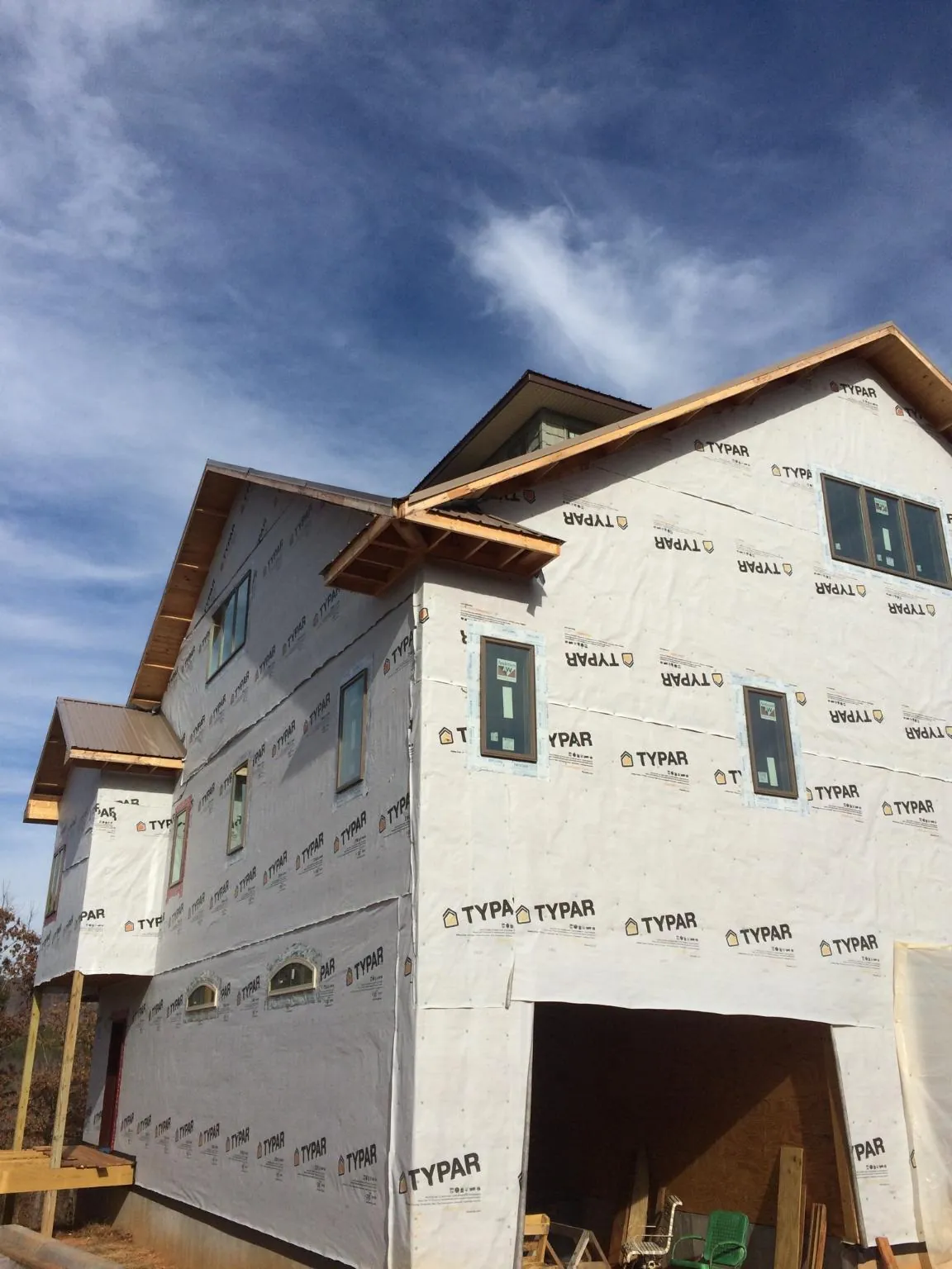 Stick built house wrapped in Typar with new roof framing and dormers in Braman